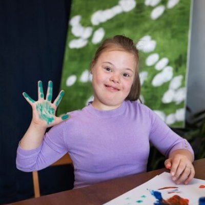 medium-shot-smiley-girl-painting_23-2149632449